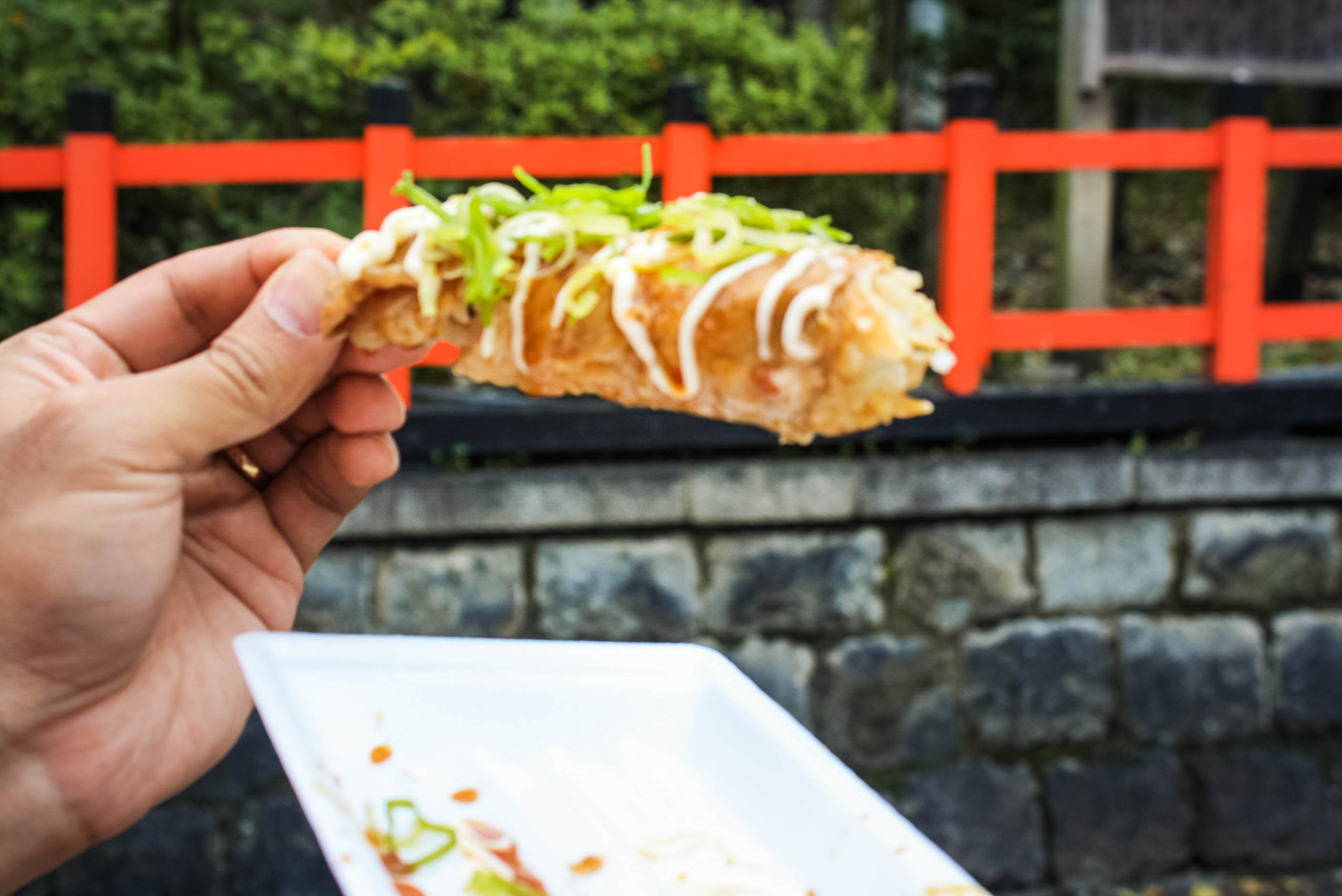 sticky rice wrapped in meat, topped with spicy mayonnaise and green onions