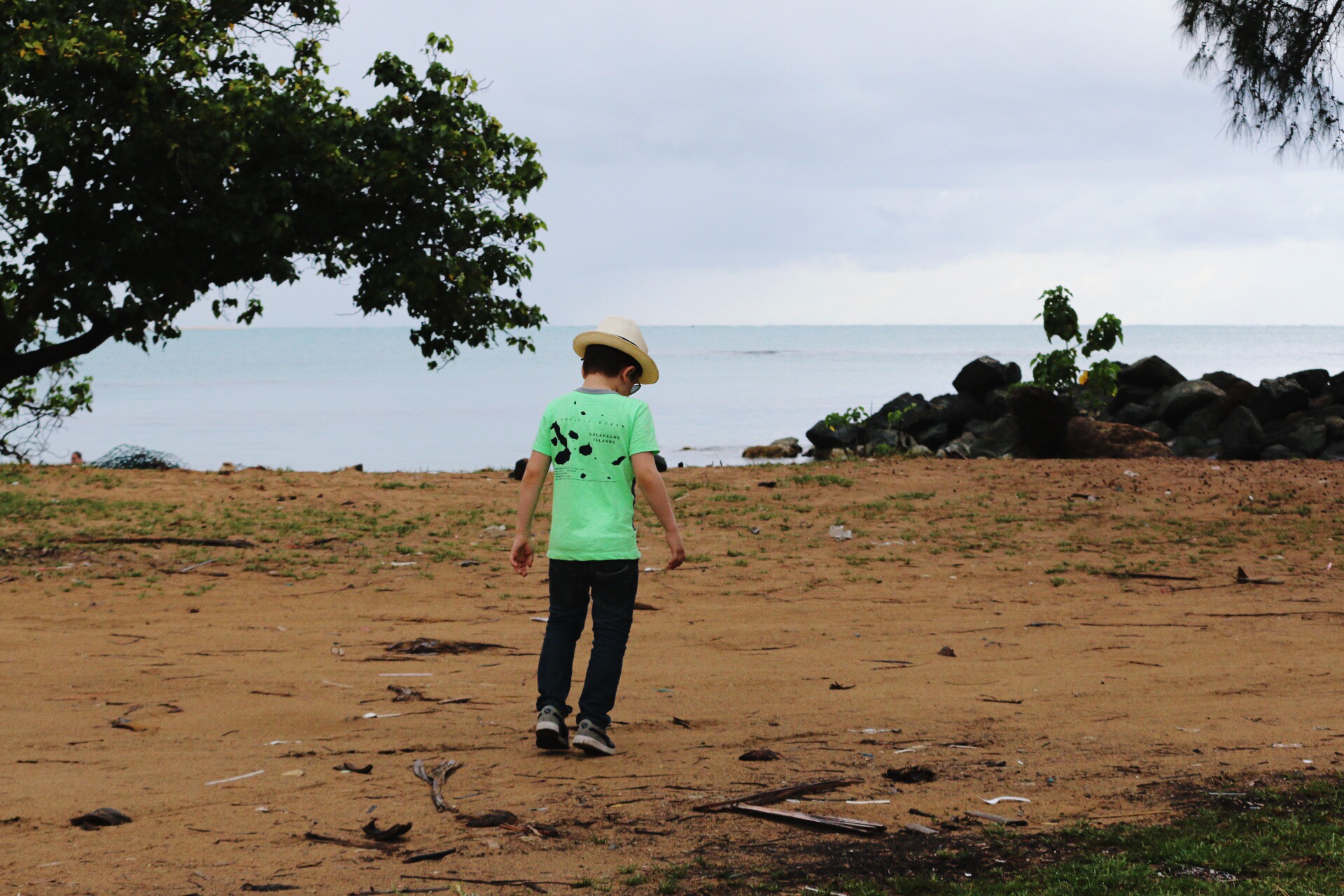 kid exploring loquillo beach on s rainy day in Puerto Rico